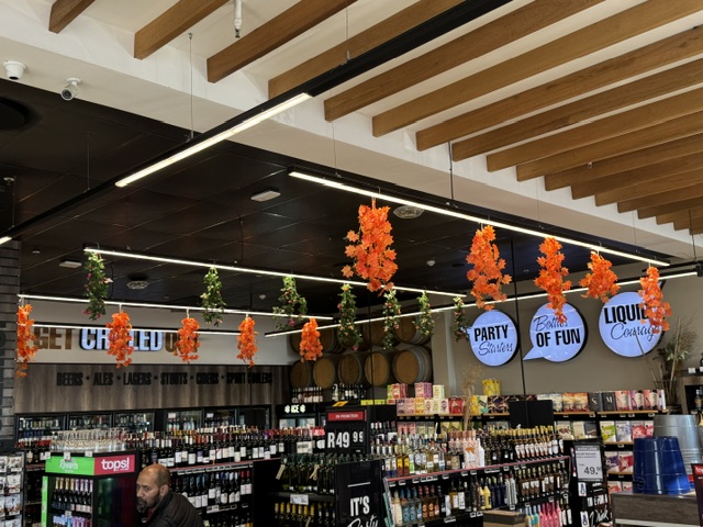 Festive decorations above the Tops liquor beer and cooler section