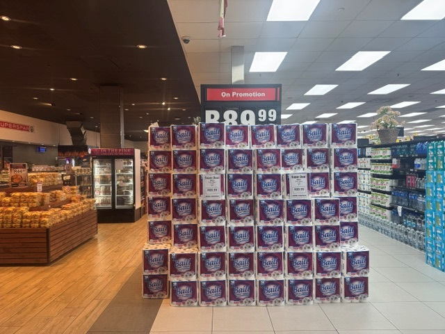 Toilet paper stacked on promotional display
