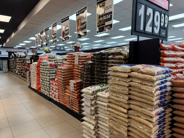 Maize meal and rice stacked on promotion in the grocery aisle